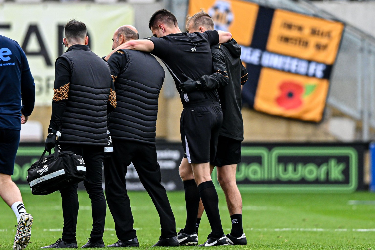 Football match suspended after referee collapsed